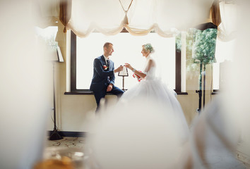 Bride and a groom with the glasses of champagne