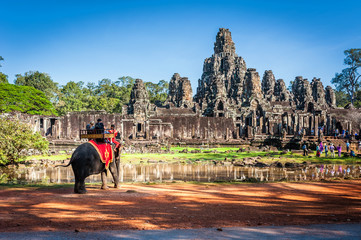 Tourists on an ride elephant tour of Bayon temple in Angkor Thom,landmark in Siem Reap, Cambodia....