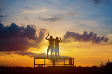 silhouette of friends in sunset,friendship concept.