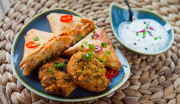 Indian Vegetable Snacks -  Pakora, Samosa, Onion Bhaji With Coriander.