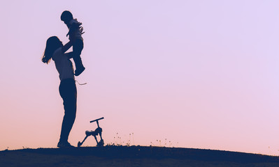 A silhouette of a happy family,mother,baby,and child