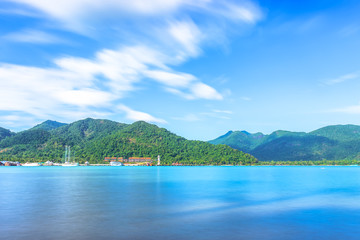 Scenic view of the harbour with mountain background against cloudy sky at Bang-Bao Koh Chang Island, (Thailand).