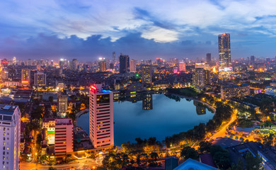 Fototapeta na wymiar Hanoi city by twilight period, with Giang Vo lake, Ba Dinh district. Aerial skyline view.
