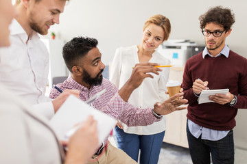 happy business team discussing something at office