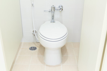 White water closet and tile floor in toilet room.