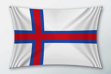 Fototapeta premium Faroe islands national flag. Symbol of the country on a stretched fabric with waves attached with pins. Realistic vector illustration.