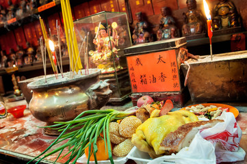 Fototapeta premium Food offerings left on the altar at Tin Hau Temple, Yau Ma Tei, Hong Kong.