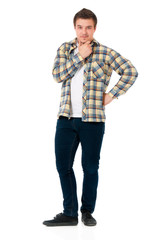Fototapeta premium Full length portrait of young man looking at camera while holding his head, isolated on white background