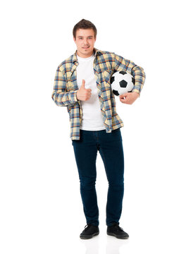Portrait of a man standing with classic soccer ball on isolated white background