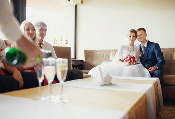 Newlyweds are celebrating in the hotel reception