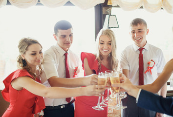 Happy cheers newlyweds with the friends