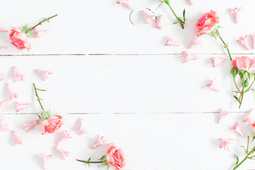 Flowers composition. Pink flowers on white wooden background. Valentine's Day. Flat lay, top view