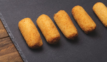 Several croquettes on a slate plate. Horizontal shoot.