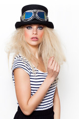 Pretty blonde girl wearing hat and strange sunglasses while looking