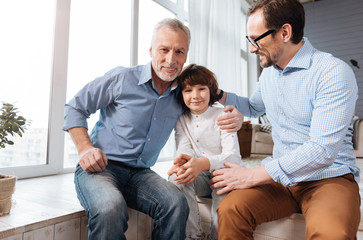 Delighted happy family sitting together