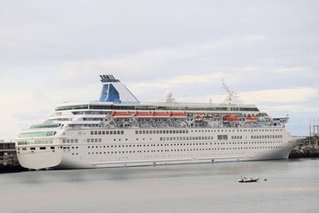 Großes weißes Kreuzfahrtschiff, im Hafen vor Anker liegend