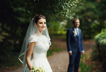 young charming bride looks into camera
