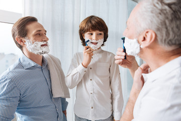 Nice young boy learning to shave