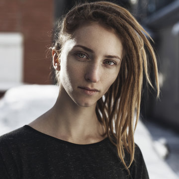 Portrait of a serious woman with dreadlocks