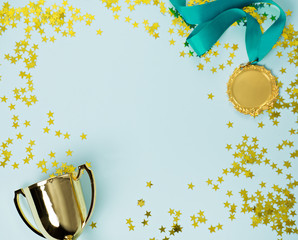 gold medal and cup on blue background