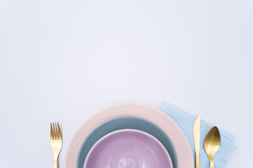 empty plates, fork, knife and spoon on table