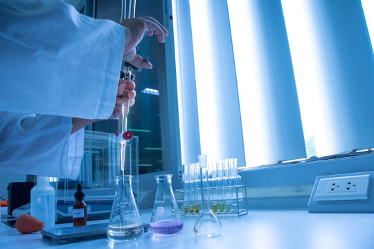 Scientist hand setting up buret or burette
