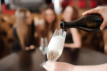 Man pours champagne in wineglasses