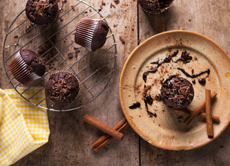 Chocolate muffins on old rustic wooden table