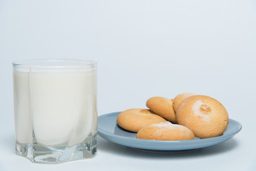 Glass of milk and plate with cookies