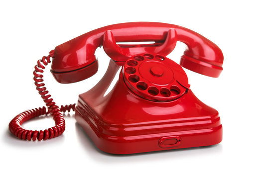Red retro telephone on white background