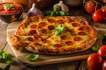 Homemade cheese pizza with salami