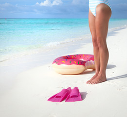 Woman legs close up on white sandy tropical beach.Summer fun travel holiday concept.