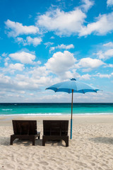 Wood bed and umbrella at sand beach of Thailand, in vacation wit