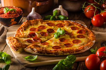 Homemade cheese pizza with salami