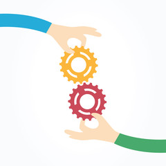 Two hands holding gears together. Teamwork, partnership, business, cooperation and management concept.