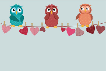 Obraz premium three cute colored owlet sitting on a string. A red hearts with a picture hanging on a rope. Valentine's Day. Vector illustration. Greeting card with empty space for the label or advertising.