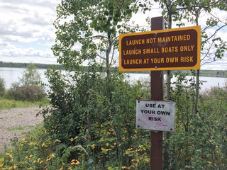 Small Unmaintained Boat Launch with Warning Signs