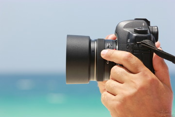 Man hands holding a digital camera making a photo. Photography concept.