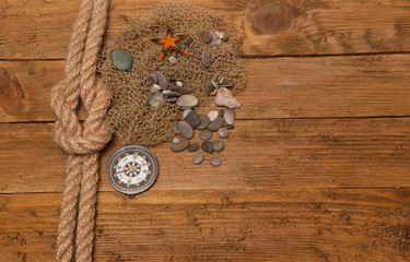 rope with marine knot,marine stones, mesh fishing on the table.