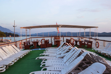 Fototapeta premium Sunbeds on the ship under the open sky, a lot of plastic beds fo