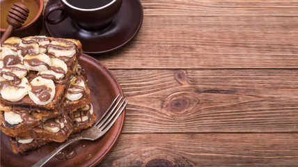French toasts with banana chocolate sauce and honey.