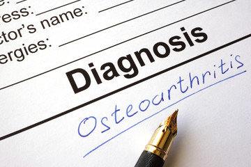 Medical form with diagnosis osteoarthritis on a table.