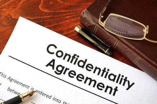 Confidentiality Agreement form on a table. Non-disclosure contract.