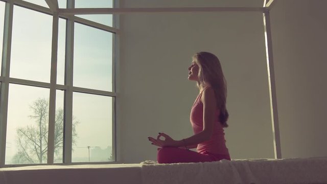 Yoga meditation of a young pretty woman