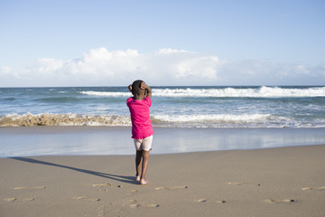 Little girl alone on beach.