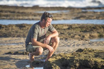 Man on rocks by ocean