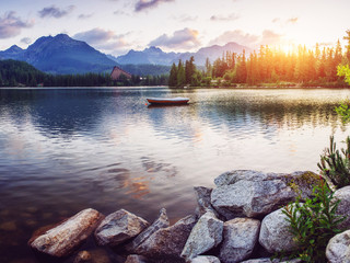 The sunrise over a lake in the park High Tatras. Shtrbske Pleso,