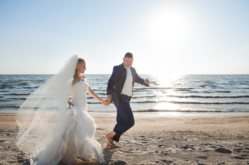 couple in love on the beach in their wedding day