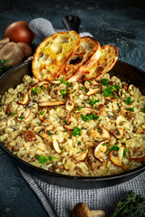 Mushroom Risotto in iron pan with herbs and parmesan cheese