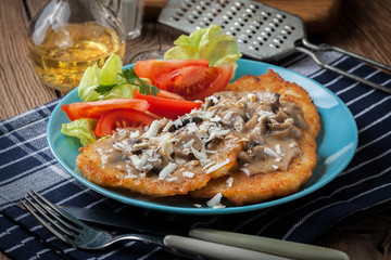 Crispy fried homemade potato pancakes with mushroom sauce.